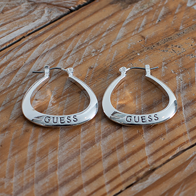 GUESS<sup>&reg;</sup> Logo Hoop Earrings - These silver tone triangle shaped hoops feature rounded edges and "Guess" engraving. Measurement 1&quot; with snapbar closure. 