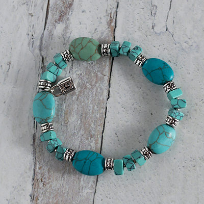 CHAPS<sup>&reg;</sup> Turquoise Stretch Bracelet - Compliment your outfit with this beautiful bracelet around your wrist. Features polished stones in varying sizes and shades of turquoise, separated by silver-tone rondelles. Once size fits all stretch styling expands for comfortable fit.
